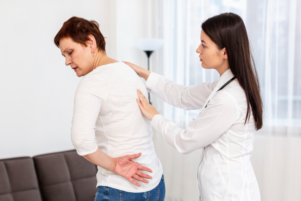 Orthopedic surgeon in Indore Dr. Tarkit Modi explaining lower back pain treatment options to a patient