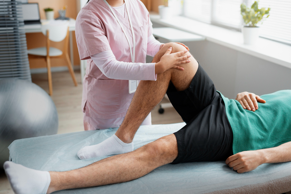 Orthopedic doctor explaining knee joint anatomy to a patient during a consultation
